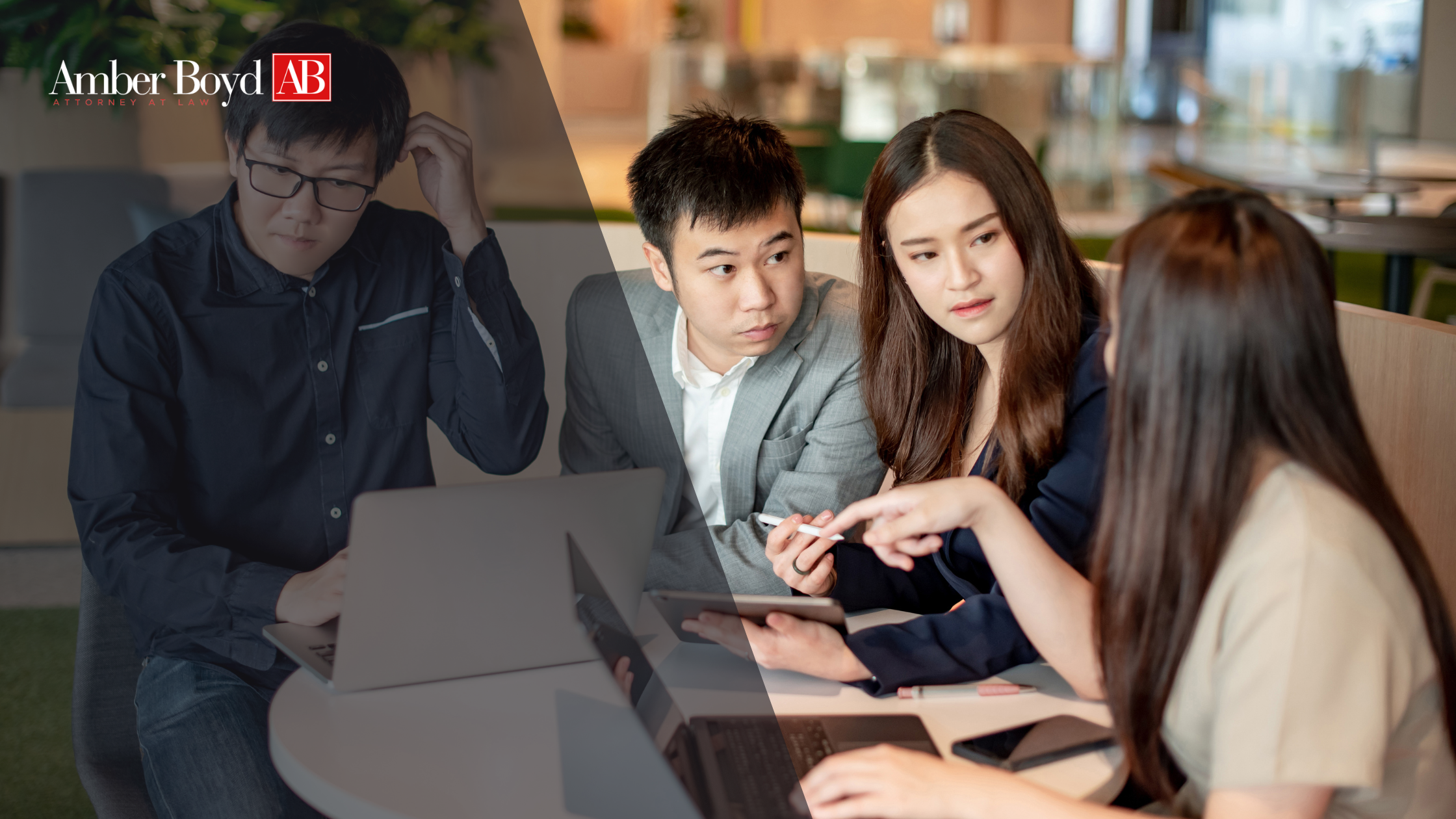 Four professionals gathered around a table in a modern office, looking at a tablet and laptops during a discussion, with Amber Boyd AB logo in the corner.